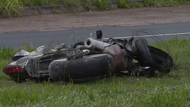 A photo shows a motorcycle resting on its side on the should of a roadway in Honolulu, Hawaiʻi.